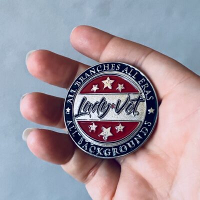 Lady Vet Challenge Coin, shown in a person's hand