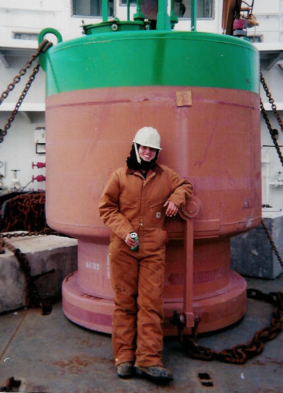 A woman in the Coast Guard, suited up for work on board a Coast Guard bouy tender